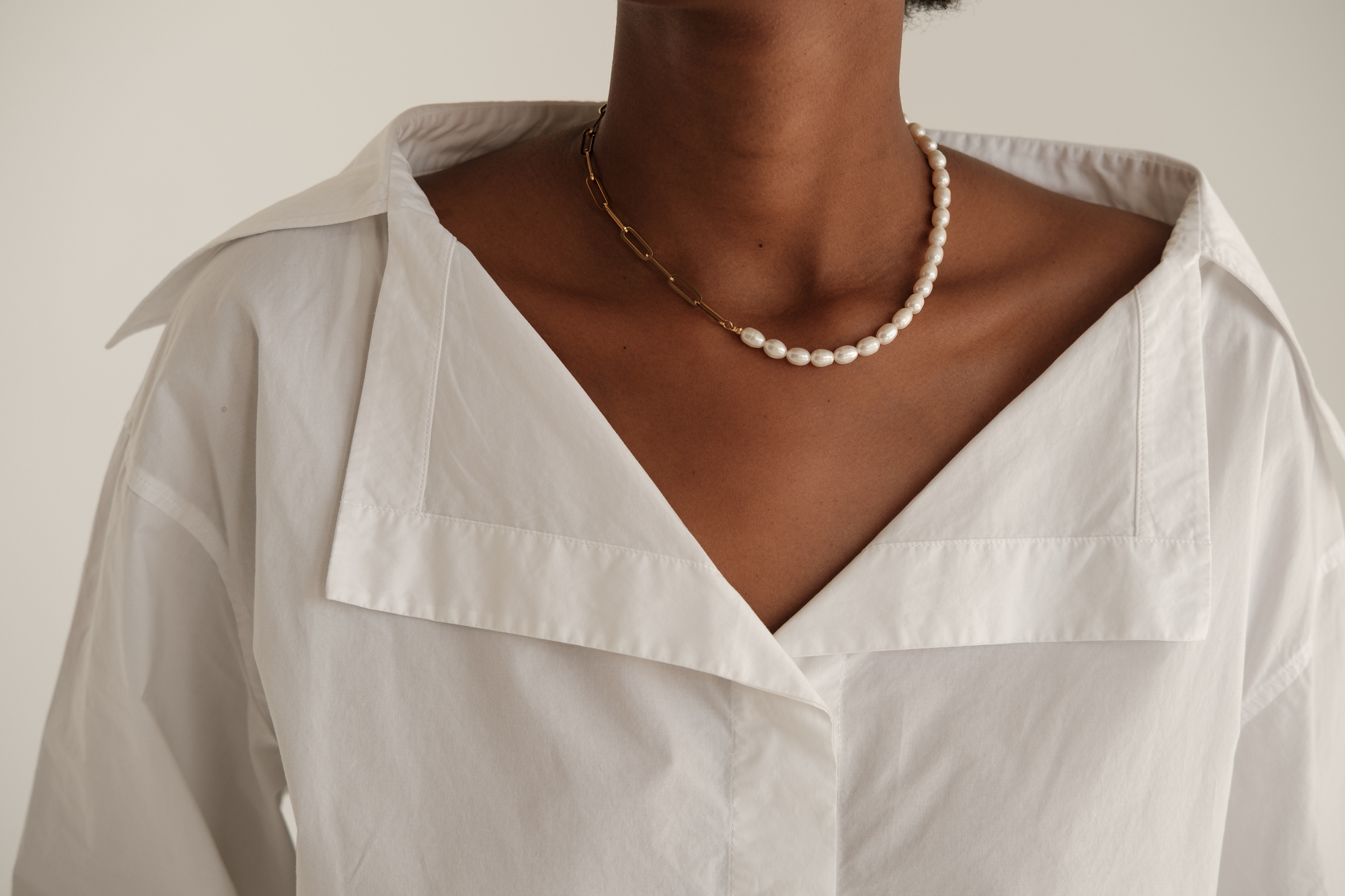 Woman in Casual Dress Shirt and Pearl Necklace